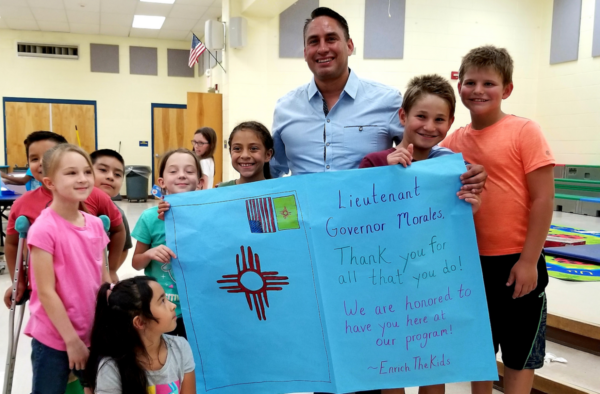 Lt Governor Howie Morales standing with children in a Head Start classroom.