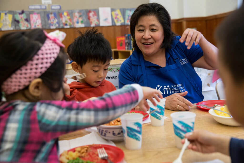 teacher engaging with children in a head start classroom