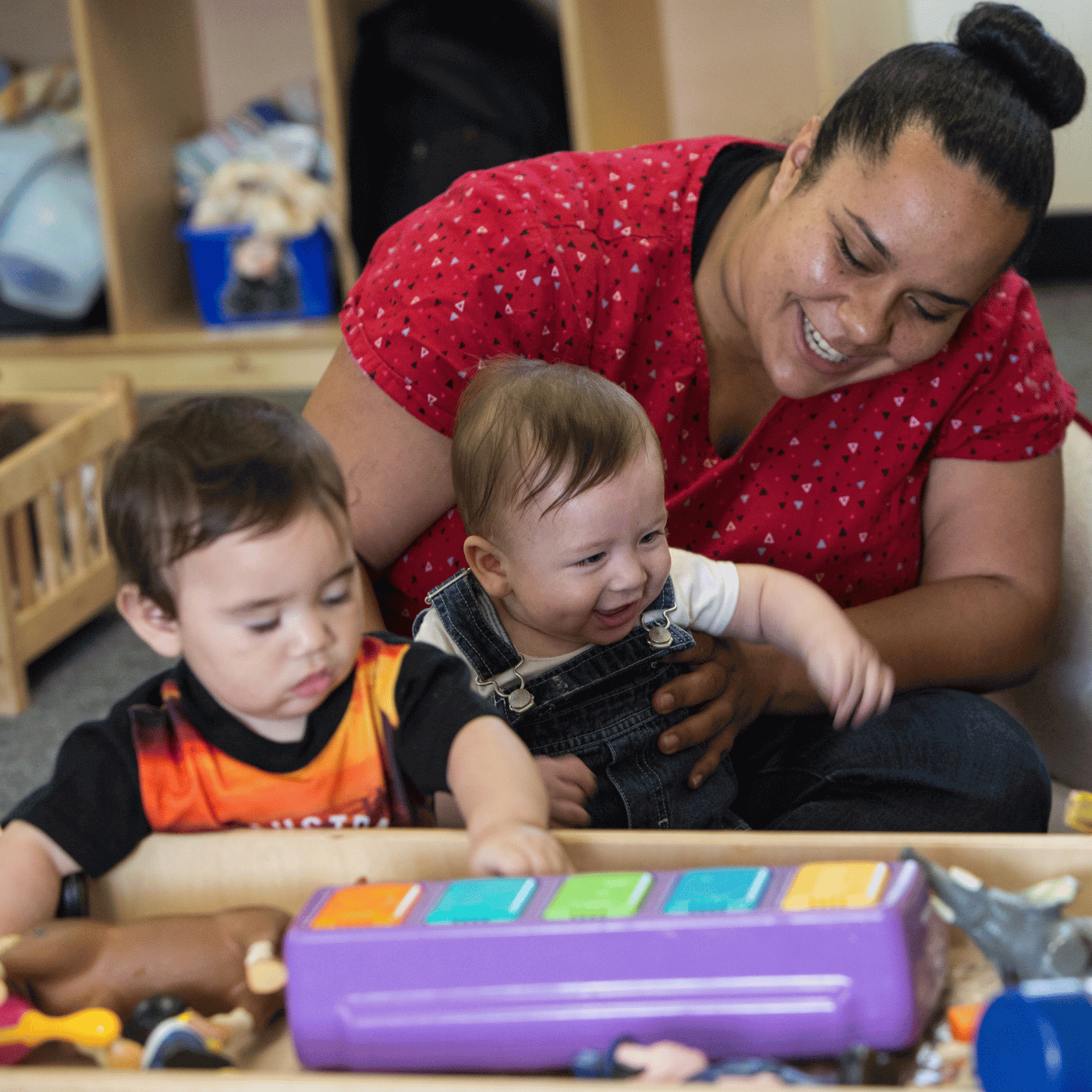 A teacher working with very young children in an Early Head Start Child Care program