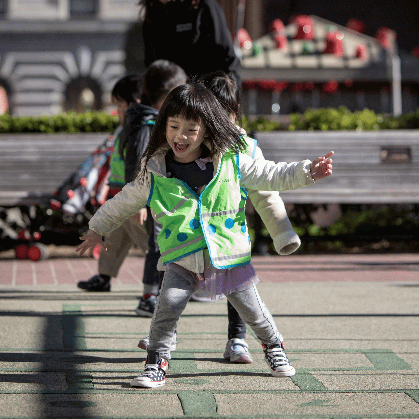 Young child playing hopscotch outside