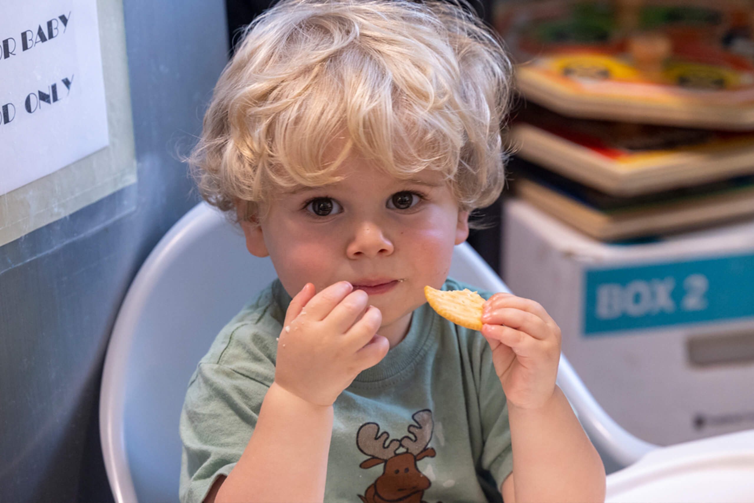 young child eating a cracker